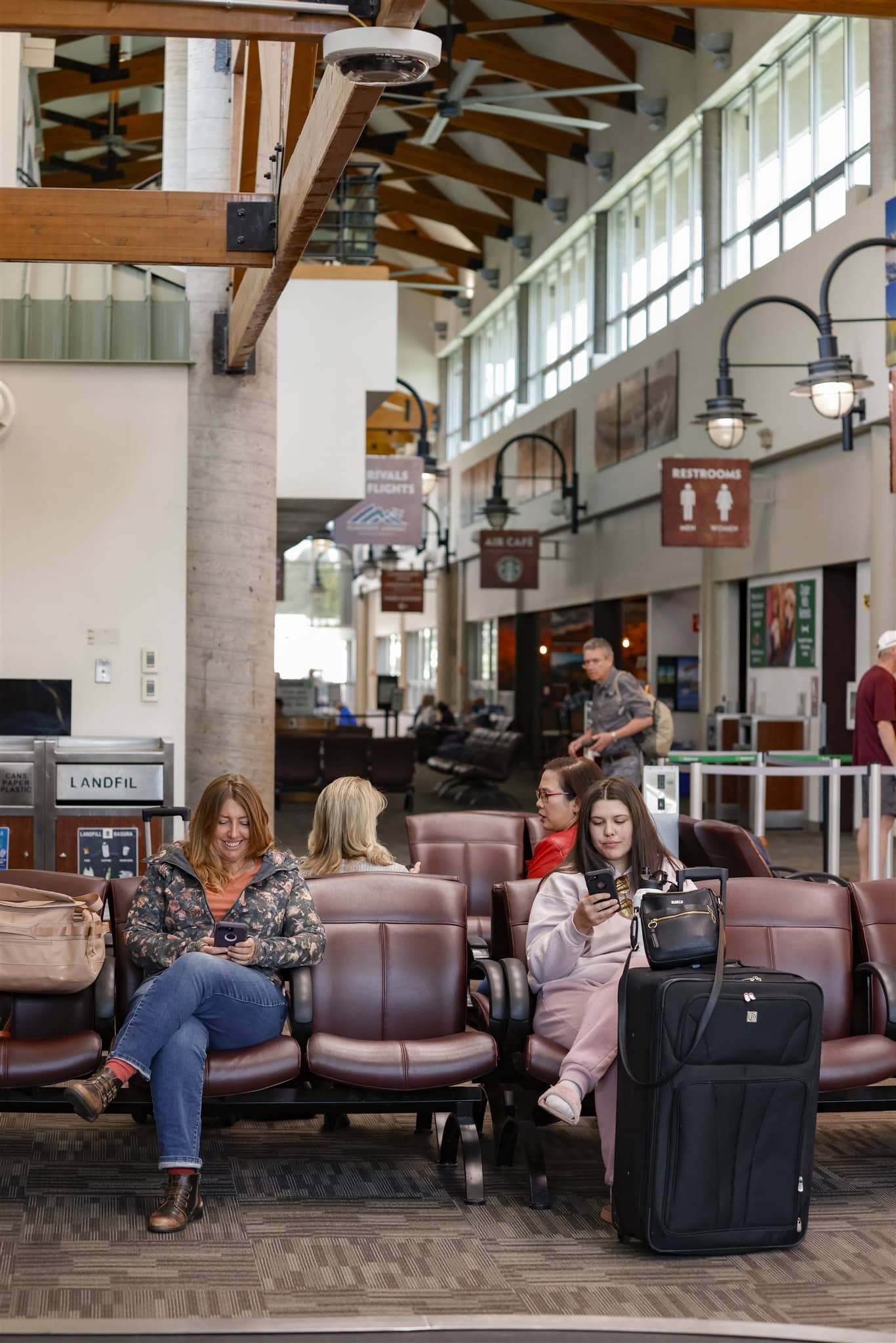 Passengers using phones inside Flagstaff Airport