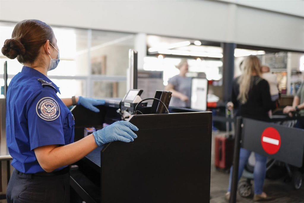 TSA Agent standing at podium in the Flagstaff Airport terminal