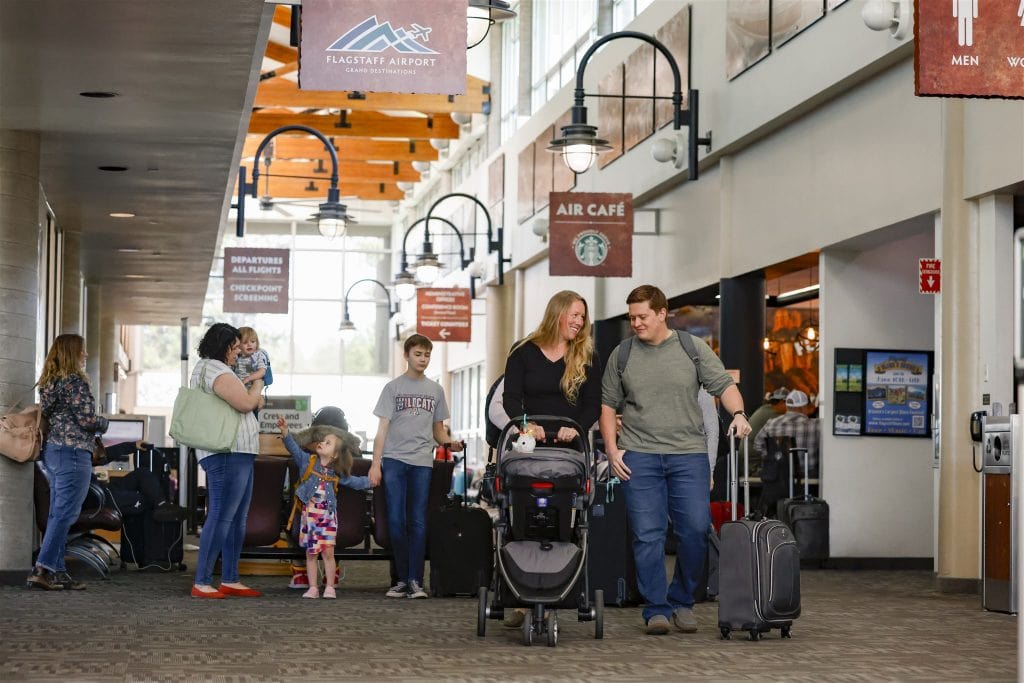 Family walking through the FLG Airport terminal